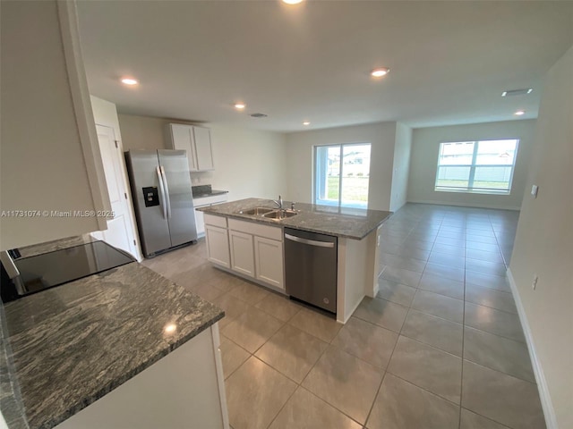 kitchen with a kitchen island with sink, white cabinets, and appliances with stainless steel finishes