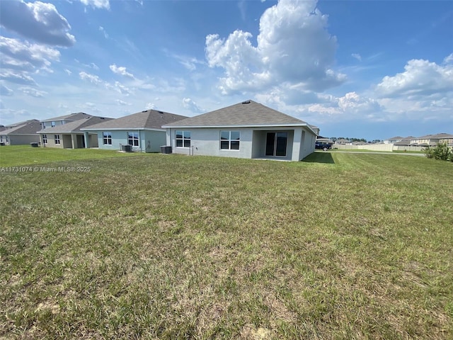 rear view of house with a yard