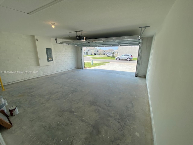 garage with a garage door opener and electric panel