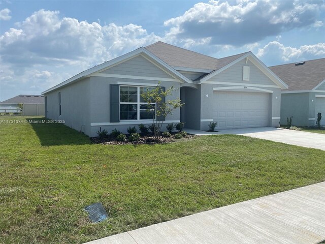 ranch-style home with a garage and a front lawn