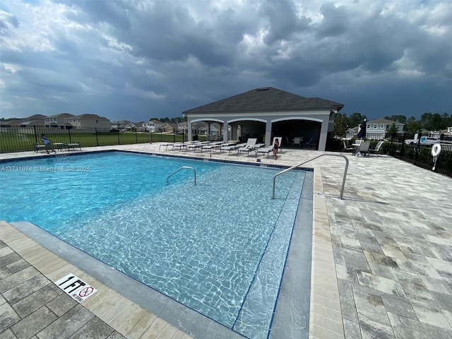 view of swimming pool featuring a patio and a gazebo