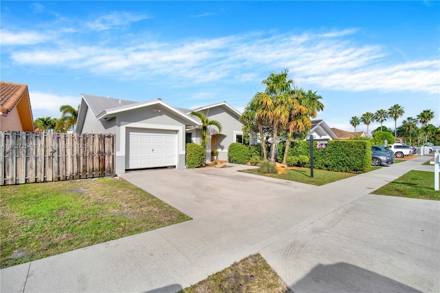 ranch-style house featuring a garage and a front lawn