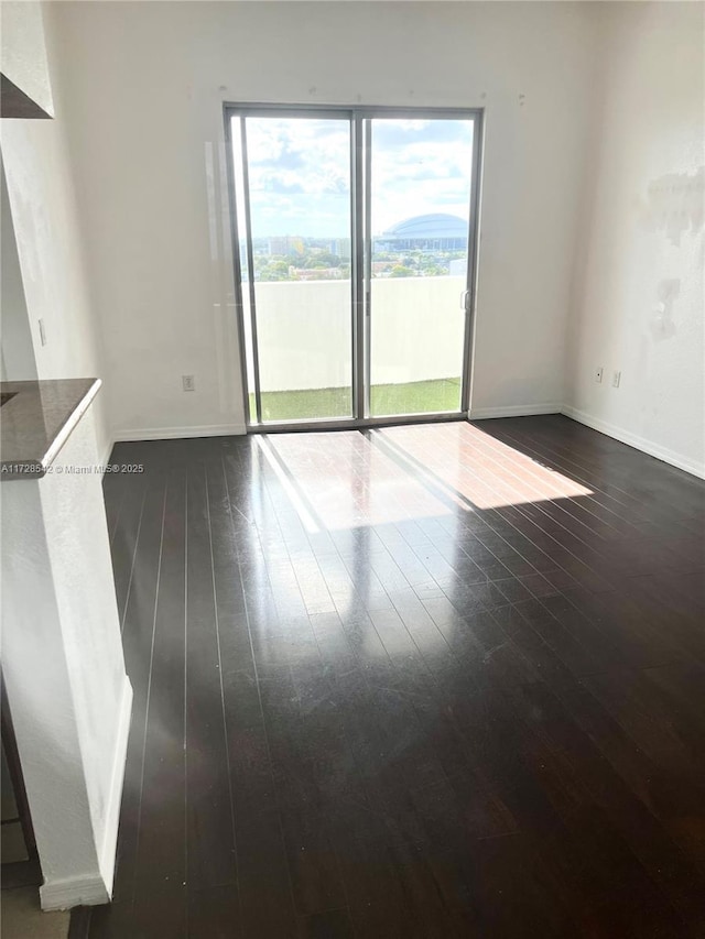 unfurnished room featuring dark hardwood / wood-style floors