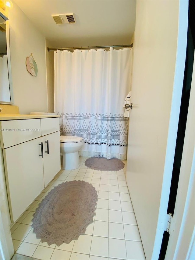 bathroom with vanity, tile patterned floors, and toilet