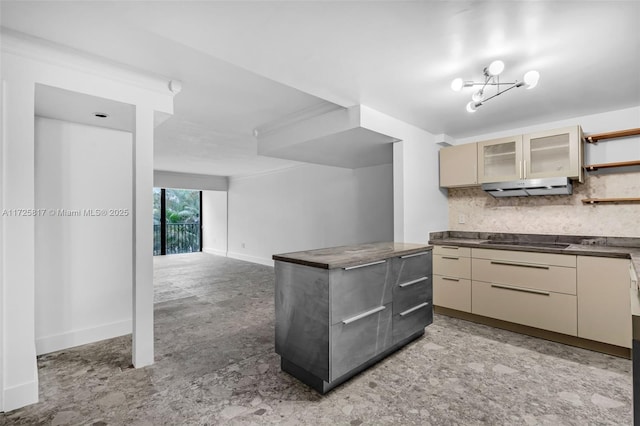 kitchen featuring black electric cooktop, cream cabinets, and tasteful backsplash