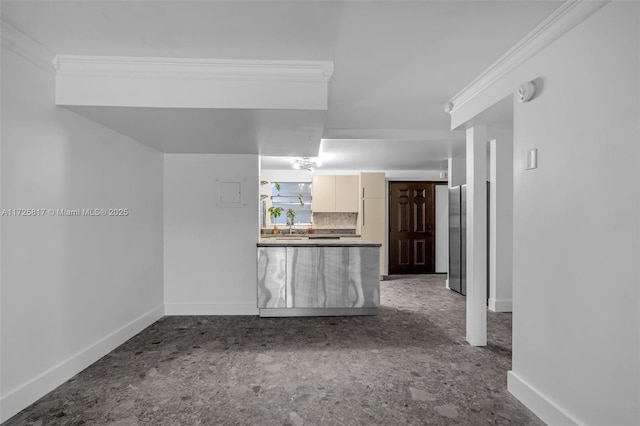 unfurnished living room with sink and ornamental molding