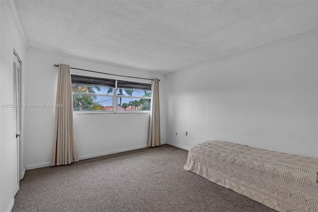 unfurnished bedroom with a textured ceiling, carpet floors, a closet, and ornamental molding