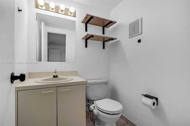 bathroom with vanity, toilet, and tile patterned floors