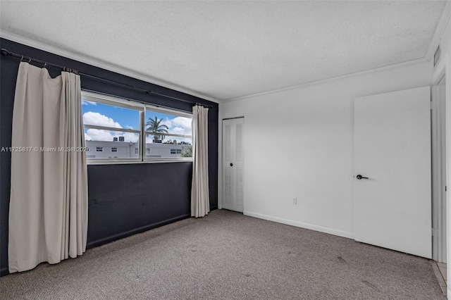 unfurnished room with a textured ceiling and carpet flooring