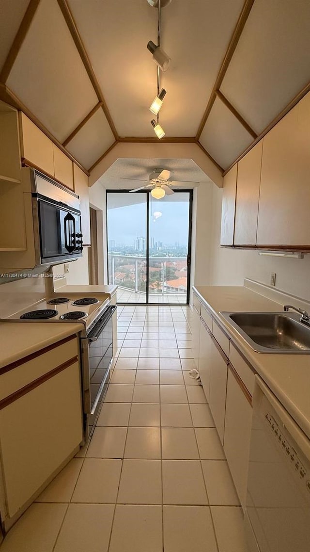 kitchen featuring light tile patterned flooring, sink, electric range oven, track lighting, and white dishwasher