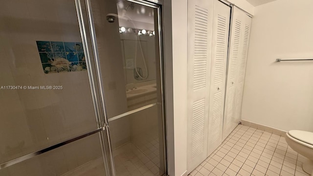 bathroom featuring sink, tile patterned floors, toilet, and walk in shower