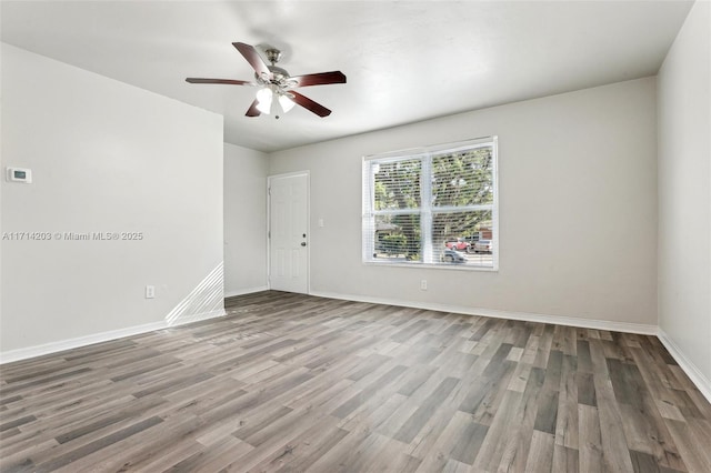 empty room with ceiling fan and hardwood / wood-style floors