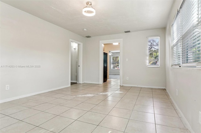 unfurnished room featuring light tile patterned floors