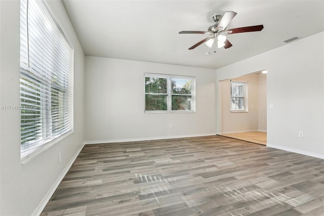 unfurnished room with light wood-type flooring and ceiling fan