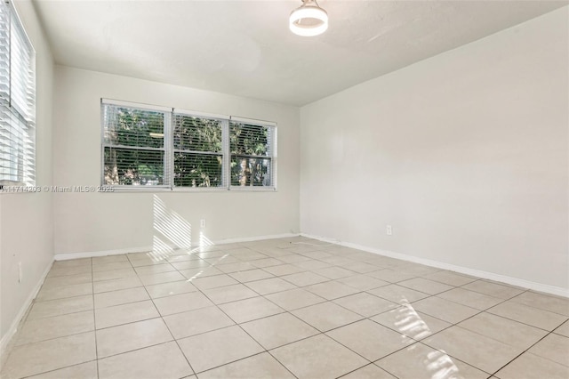 unfurnished room with light tile patterned floors