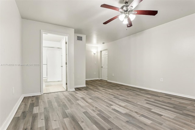 spare room with light wood-type flooring and ceiling fan