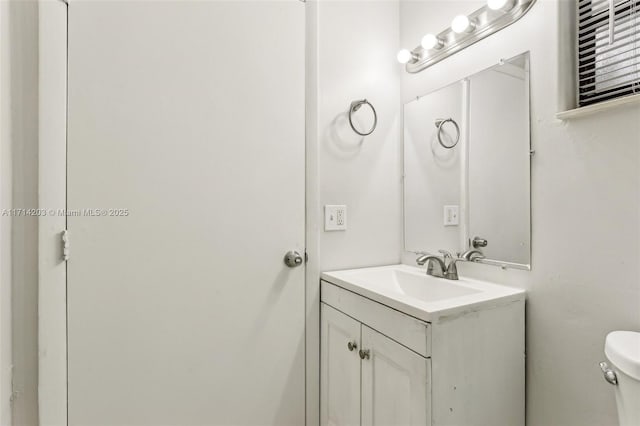 bathroom with toilet and vanity