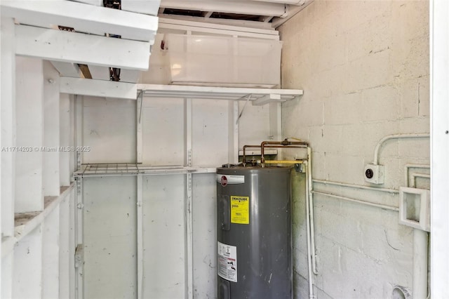 utility room featuring water heater