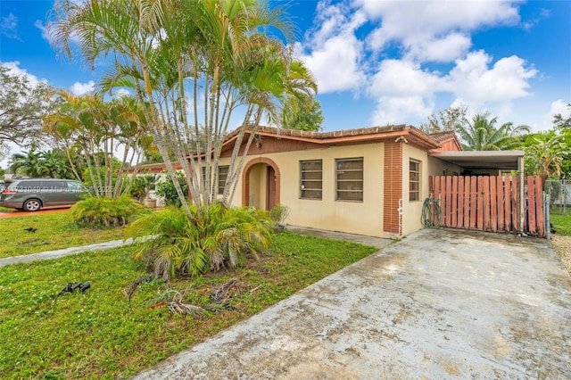 mediterranean / spanish-style house with a carport