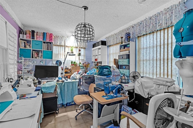 tiled home office featuring plenty of natural light, a textured ceiling, and an inviting chandelier