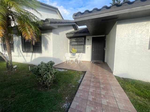 doorway to property with a patio area