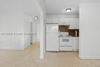 kitchen featuring white appliances and white cabinetry