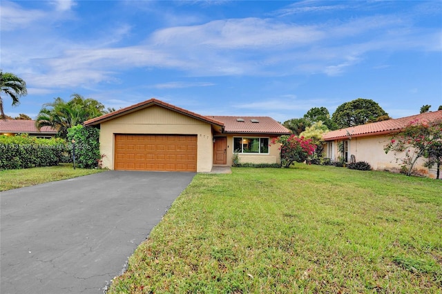 ranch-style house with a garage and a front yard