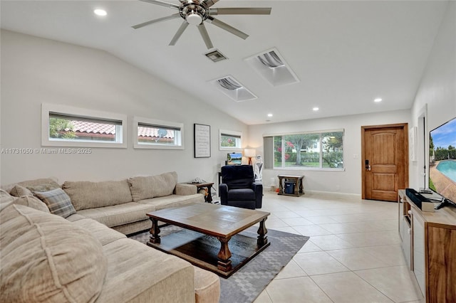 living room with ceiling fan, lofted ceiling, and light tile patterned floors