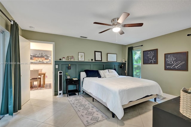 bedroom featuring light tile patterned floors and ceiling fan