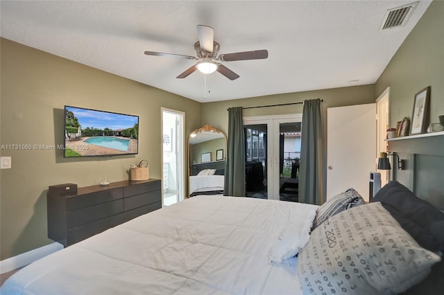 bedroom with ceiling fan, access to exterior, and a textured ceiling