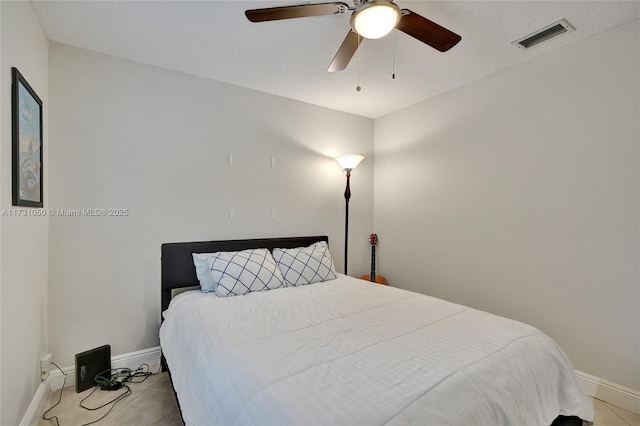 tiled bedroom with ceiling fan