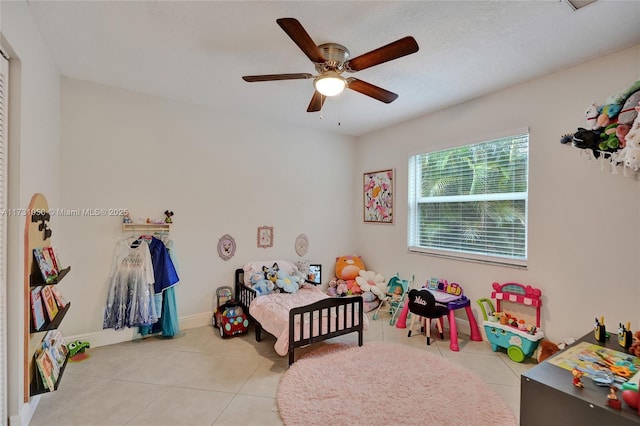 bedroom with ceiling fan and light tile patterned floors