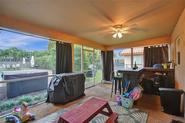 sunroom featuring ceiling fan