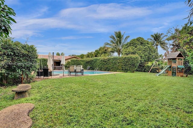 view of yard with a playground and a fenced in pool