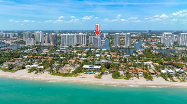 aerial view with a water view and a view of the beach