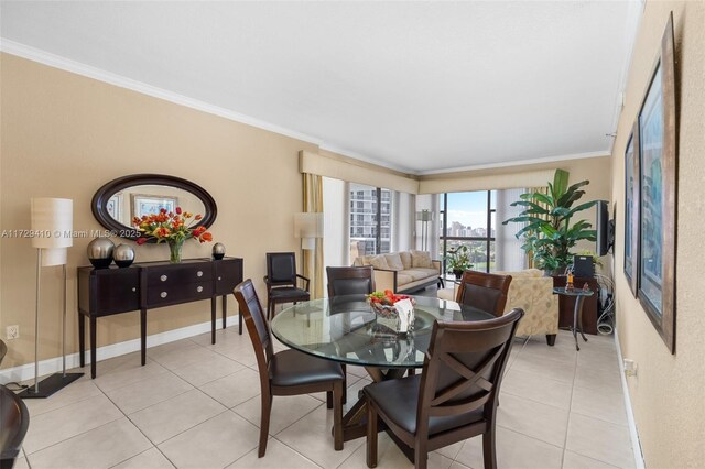 tiled dining room featuring ornamental molding