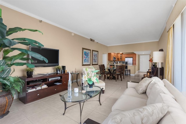 living room featuring crown molding and light tile patterned floors