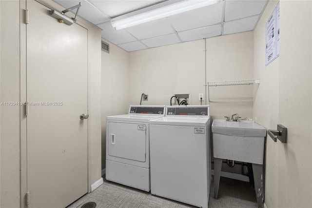 washroom with sink and washing machine and dryer