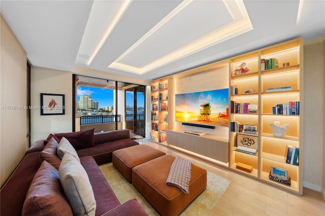 living room featuring light hardwood / wood-style flooring and a wall of windows