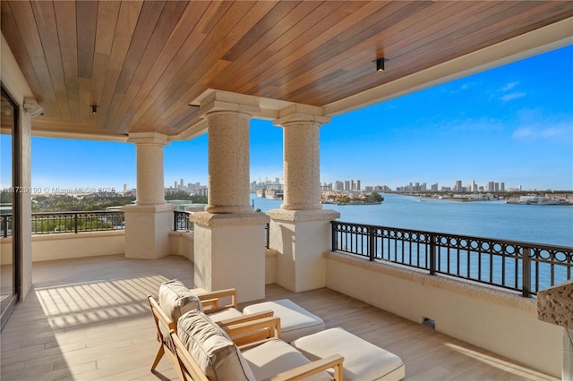 view of patio / terrace with a balcony and a water view