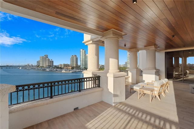 view of patio / terrace with a balcony, a water view, and ceiling fan