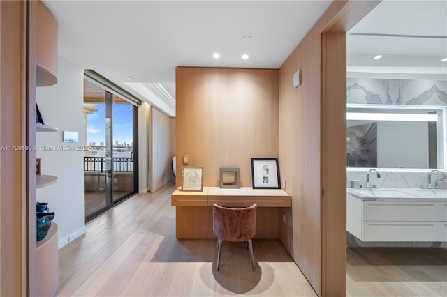 office area featuring sink and light hardwood / wood-style floors