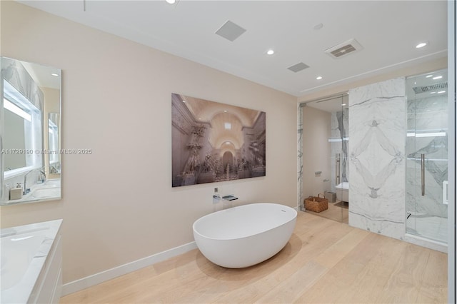 full bathroom featuring vanity, hardwood / wood-style floors, shower with separate bathtub, and toilet