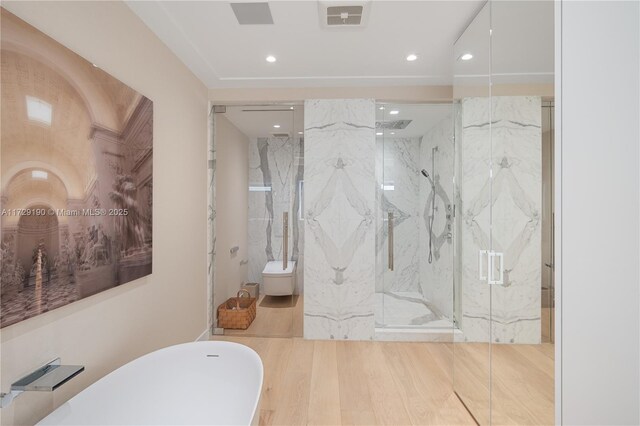 bathroom with a shower with door, wood-type flooring, and toilet