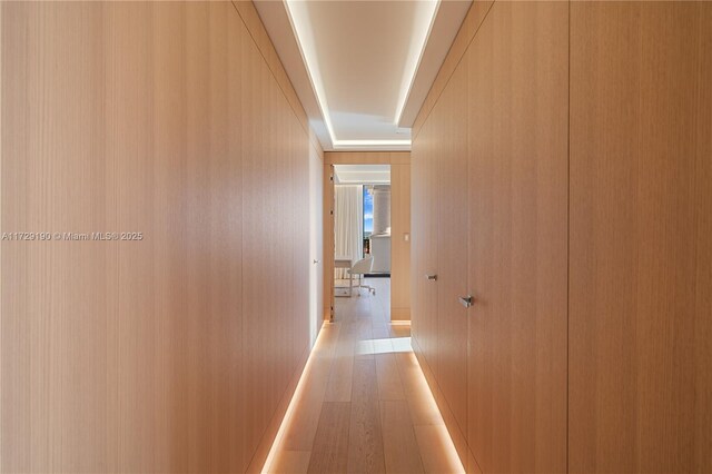 hallway with light hardwood / wood-style flooring