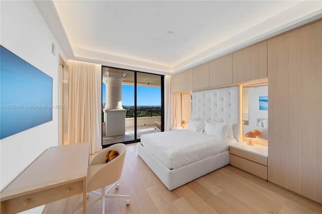 bedroom featuring access to exterior and light hardwood / wood-style floors