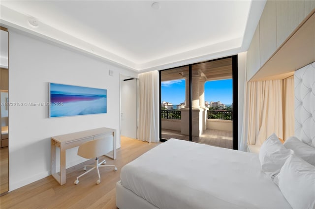 bedroom featuring access to exterior and light hardwood / wood-style floors