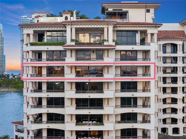 outdoor building at dusk featuring a water view