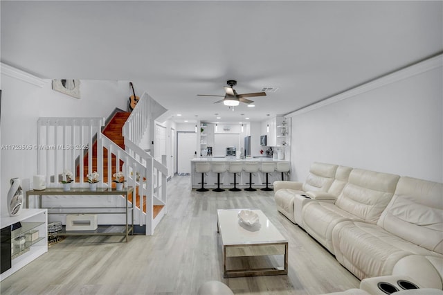 living area with recessed lighting, visible vents, a ceiling fan, stairs, and light wood-type flooring