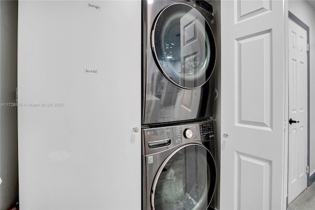 clothes washing area with laundry area and stacked washer / dryer